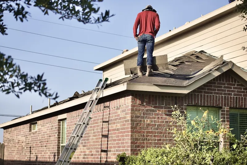 Professional roofer working on a residential roof in Elm Hill